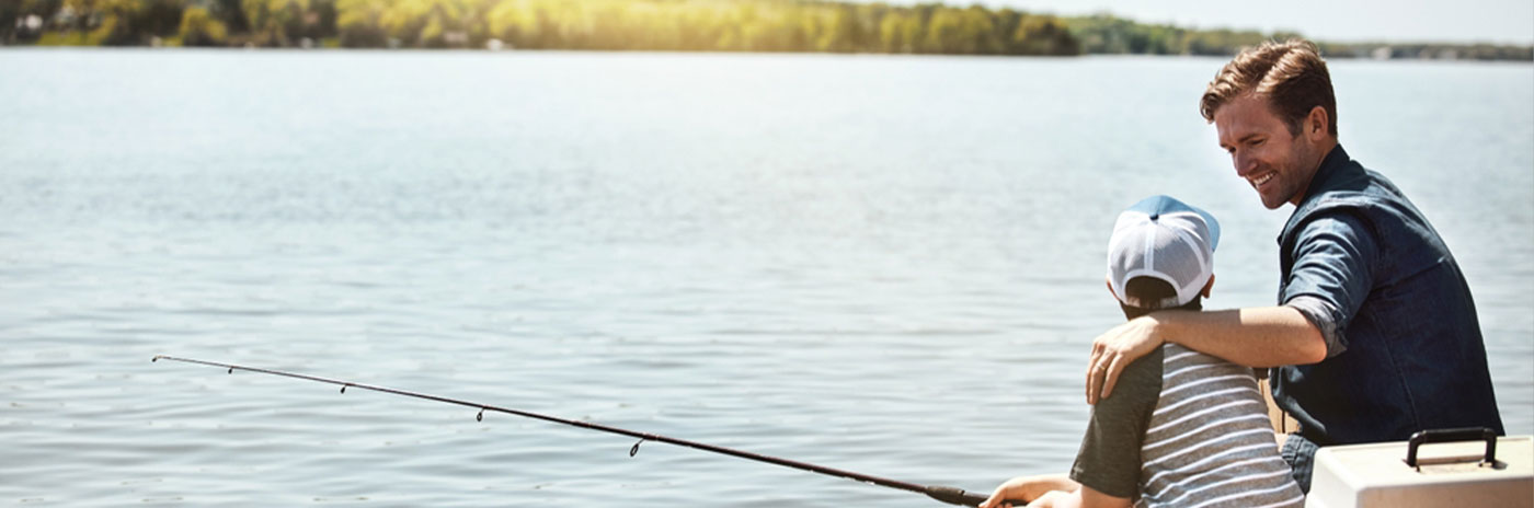 dad and son fishing on a lake